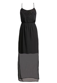 Černé maxi šaty vyrobené z lehkého materiálu, s krajkovým živůtkem, tenkými ramínky a průhlednou dolní částí s bočními rozparky.