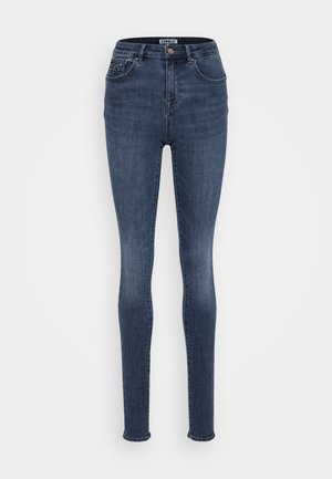 Tætsiddende jeans i mørkeblå denim med en middels højde talje, der har frontlommer, en enkelt metalknap lukning og minimal slidtage.