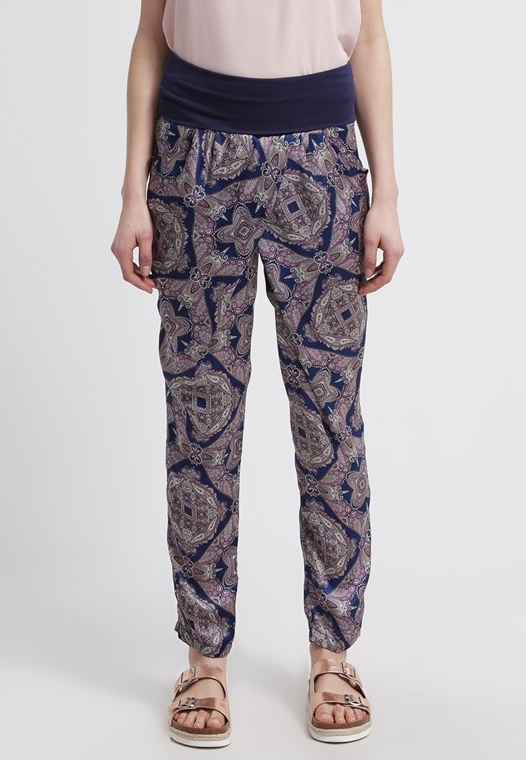 Elasticated waist trousers in navy with intricate paisley pattern in purple and green. Lightweight fabric, tapered ankles, and side pockets.