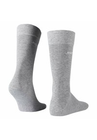 Calcetines de algodón grises con puños acanalados y textura suave. Presenta detalles sutiles del logo en el lateral. Diseño estándar de longitud hasta el tobillo.