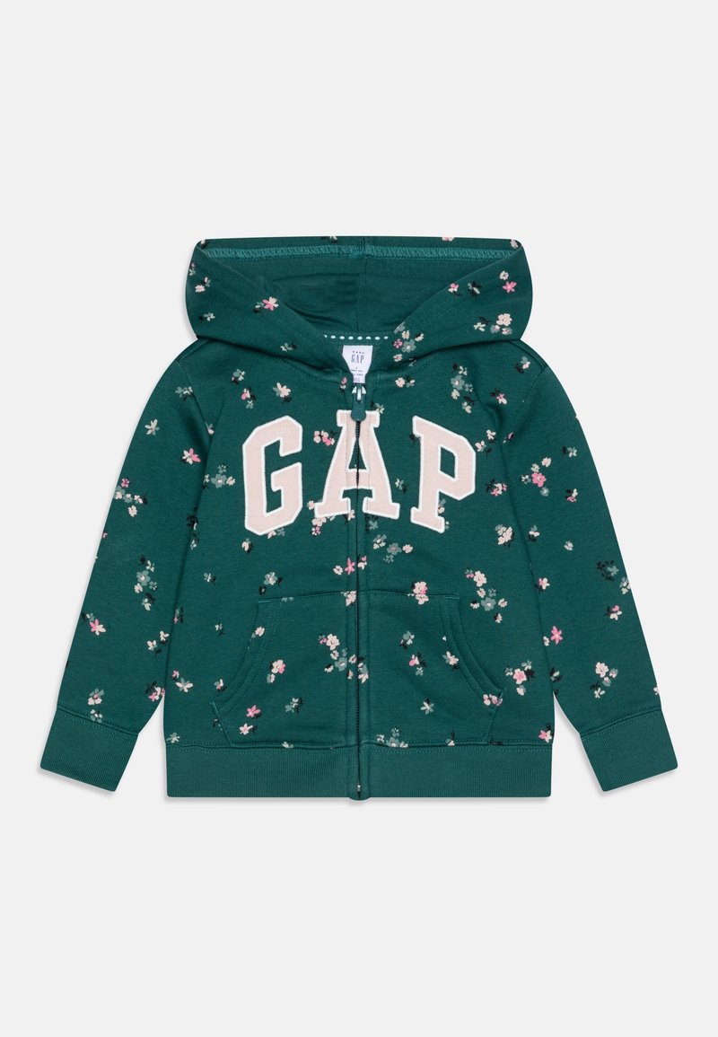 Sweat à capuche zippé vert foncé à fleurs, taille enfant, avec poches sur le devant et logo "GAP" en grandes lettres blanches sur la poitrine.