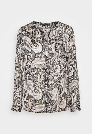 Chemisier transparent à manches longues présentant un motif cachemire noir, blanc et beige, avec une fermeture à boutons sur le devant et un ourlet arrondi.