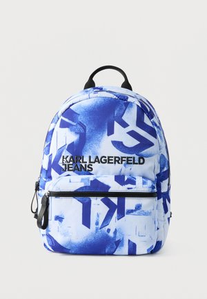 Mochila de patrones azules y blancos con el logo "KARL LAGERFELD JEANS", bolsillo frontal con cremallera y asa negra en la parte superior.