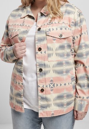 Cotton jacket featuring a geometric pattern in pastel pink, blue, and cream, with two front pockets and dark buttons.