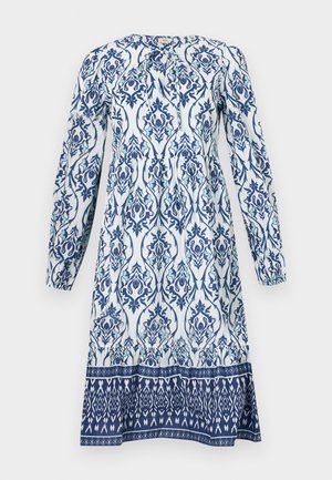 Long-sleeve dress featuring a white base with blue and teal floral patterns. Gathered bodice and a contrasting patterned hem.