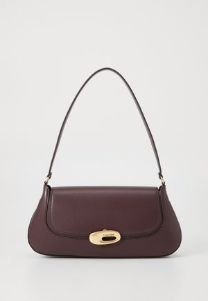 Burgundy leather handbag with a curved shape, adjustable shoulder strap, and a gold hardware clasp featuring the Calvin Klein logo.