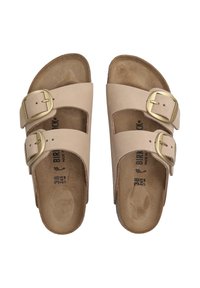 Sandales en cuir beige avec deux boucles métalliques ajustables, semelle en liège moulée et semelle intérieure texturée, étiquetées avec des informations de taille.