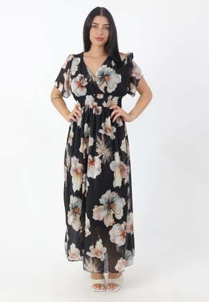 Robe maxi avec un fond noir agrémenté de grands motifs floraux dans des couleurs douces, des manches courtes en volants et un détail de taille froncée.