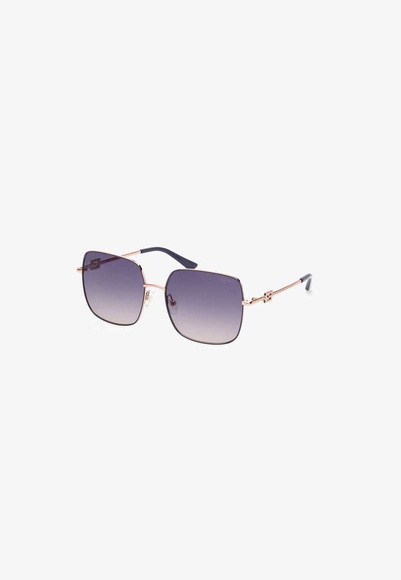 Ochelari de soare pătrați cu lentile violet cu gradient. Rame subțiri metalice aurii și brațe de urechi de culoare albastru închis. Prezentă accente de marcă pe temple.