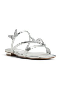 Silver metallic sandals with multiple slender straps and decorative butterfly accents featuring rhinestones. Flat sole with a subtle heel.