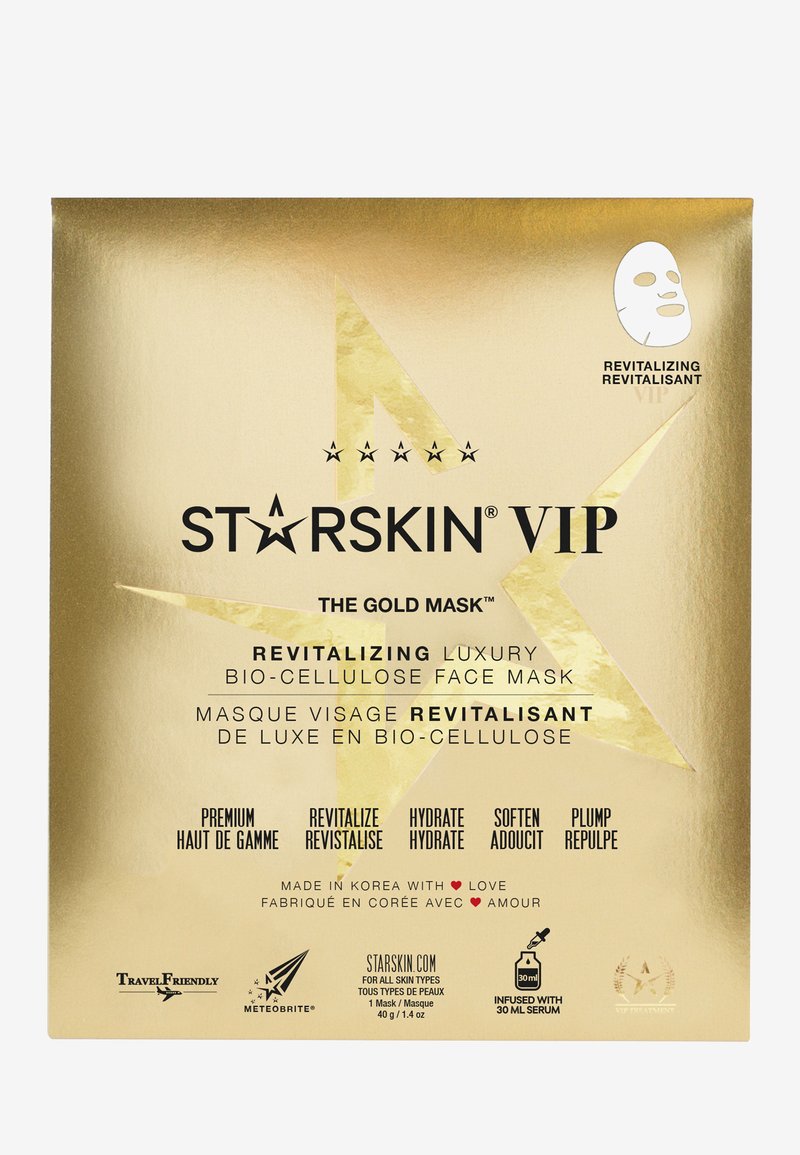 Un emballage doré avec un texte noir en gras annonçant "STARSKIN VIP THE GOLD MASK." Comprend une icône de masque facial et des détails sur les propriétés revitalisantes.