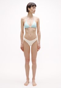 Helehall sinise soonikkoes kolmnurkse bikiinitopiga, millel on reguleeritavad rihmad, sobitatud kreemja kõrge vöökohaga bikiinipõhjaga. Lihtne ja minimalistlik disain.