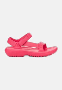 Rosa sandaler med en formad design, som har justerbara remmar och en texturerad sula för grepp, tillverkade av lätt syntetiskt material.