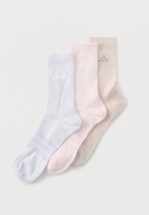 Drie geribbelde kniekousen in lichtblauw, bleekroze en beige, elk met een subtiel logo vlak bij de boord.