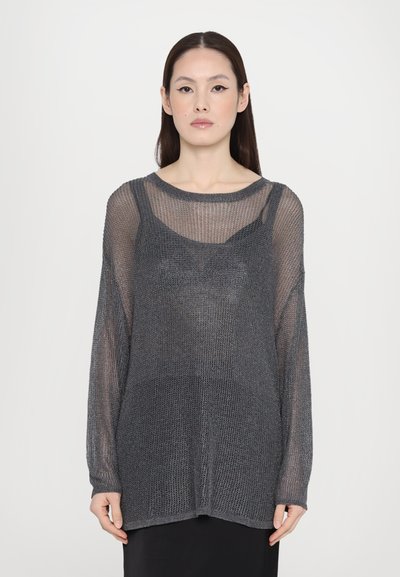 Grå, let strikket sweater med løs pasform, lange ærmer og et lagdelt design over en tætsiddende top, der har en gennemsigtig tekstur.