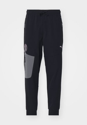 Schwarze Sporthose mit grauem Einsatz, elastischem Bund, Kordelzug und Logodetail. Enganliegende Passform mit gerippten Bündchen.