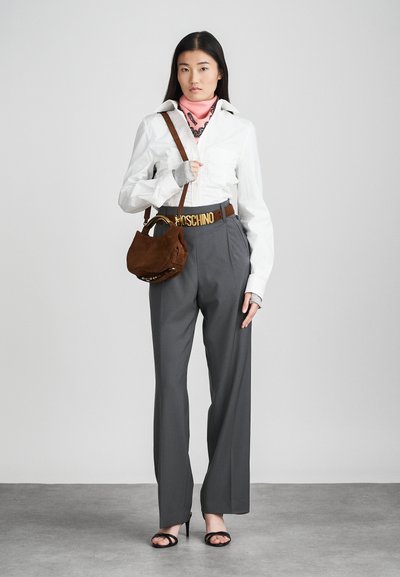 White long-sleeve shirt, gray tailored pants, brown suede handbag, pink bandana, gold-buckled belt, and black open-toe heels.