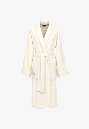 Accappatoio morbido color crema con collo sciallato, cintura in vita e due tasche frontali, una delle quali decorata con un ricamo floreale sobrio.
