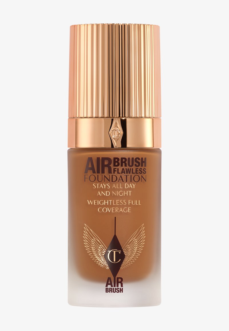 Air Brush Flawless Foundation in a glass bottle with a gold ribbed cap. Dark brown liquid inside, labeled with claims of full coverage and longevity.