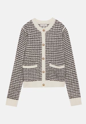 Gilet tricoté en crème et marine avec des rayures horizontales, doté de boutons en perles rondes et de deux poches avant. Poignets côtelés.