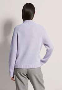 Lila Pullover mit hohem Rippkragen, strukturierten Strickärmeln und einem flach gestrickten Körper. Mit einem gerippten Saum und Bündchen.