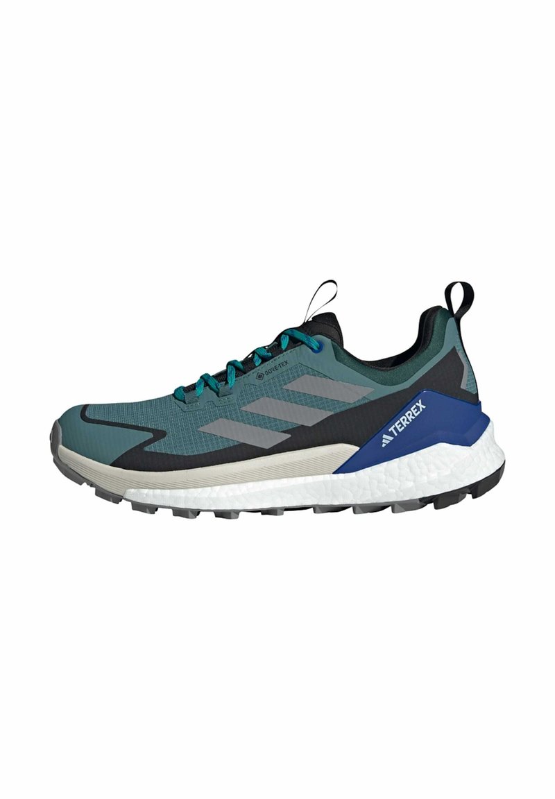 Trail running shoe in teal, gray, and black. Features a textured upper, lacing system, GORE-TEX branding, and a cushioned white midsole.