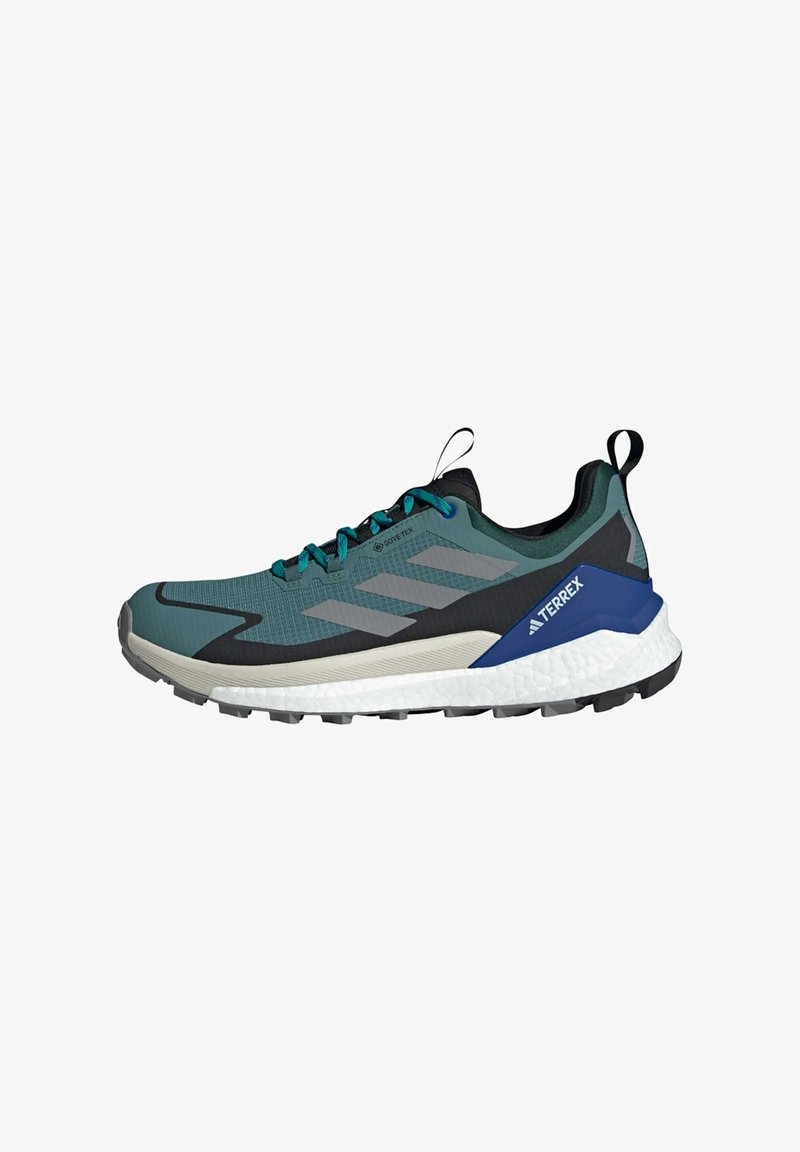 Trail running shoe in teal, gray, and black. Features a textured upper, lacing system, GORE-TEX branding, and a cushioned white midsole.