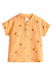 Orange bomulds t-shirt med korte ærmer, med en frontknap-lukning og et tryk af bjørne ansigt og omrids overalt.