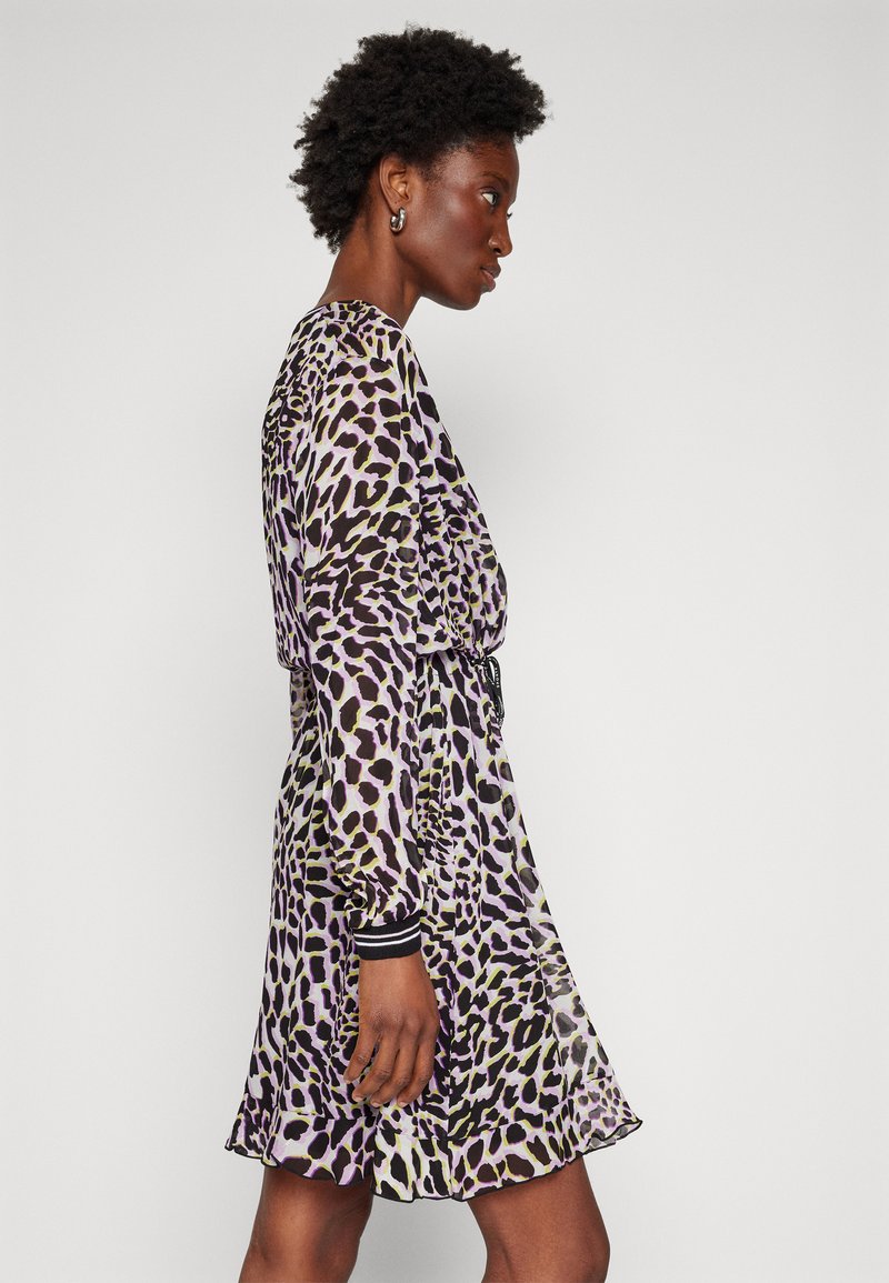 Purple leopard-print dress made of sheer fabric, featuring long sleeves with black ribbed cuffs and a cinched waist for a flowing silhouette.