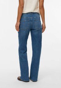 Blue denim straight-leg jeans with a mid-rise waist, featuring back pockets and a classic five-pocket design. Smooth texture, minimal stitching.