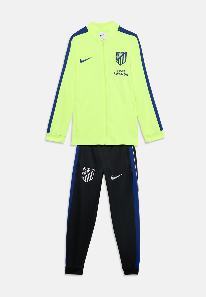 Veste jaune néon avec des rayures bleues et pantalon noir avec les logos Atlético Madrid et Nike, et texte "Visit Rwanda" sur la veste.