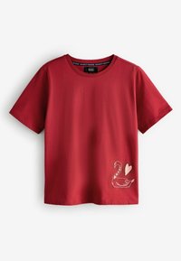 Red cotton t-shirt with short sleeves, featuring a swan and heart graphic in white at the bottom left corner. Classic crew neckline.