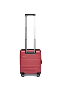 Valigia rigida rossa con texture scanalata, manico grigio retrattile e quattro ruote nere. Design compatto adatto per i viaggi.
