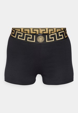 Boxer shorts noirs avec une ceinture dorée contrastante ornée d'un motif de clef grecque et d'un médaillon logo central. Matériau doux et extensible.