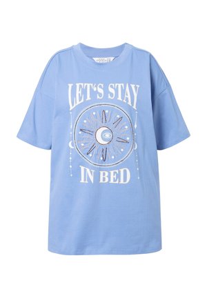 Light blue short-sleeve T-shirt featuring a circular graphic with a crescent moon, sun, and text "LET'S STAY IN BED" in white.