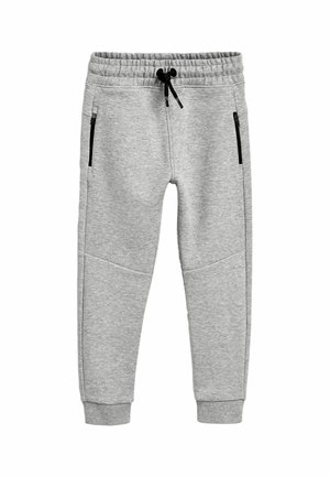 Pantalon de jogging gris clair avec taille élastique, cordon noir, poches latérales zippées et chevilles resserrées, posé à plat sur fond blanc.