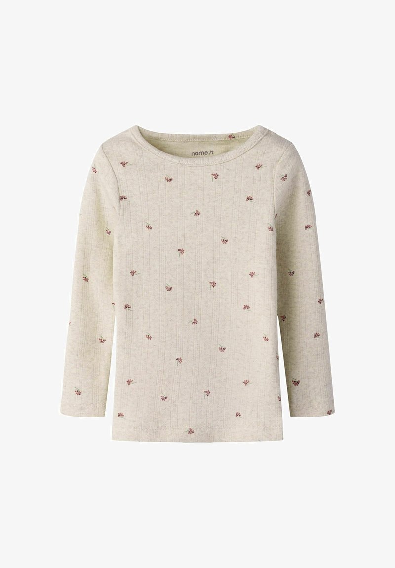 Maglia a maniche lunghe color bianco sporco con stampa di piccole bacche rosse sparse e scollo rotondo.