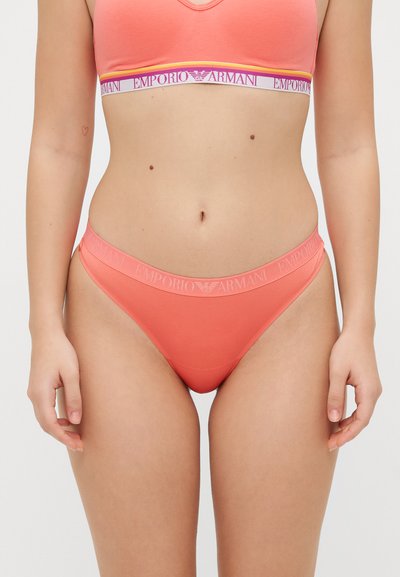 Coral cotton bralette and thong set with elastic Emporio Armani logo bands. Smooth texture, fitted design, and minimal coverage.