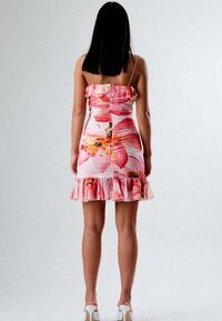 Abito stampato floreale con spalline sottili, scollatura a volants e orlo ondulato. Presenta tonalità di rosa e arancione, forma aderente e chiusura con bottoni sul retro.
