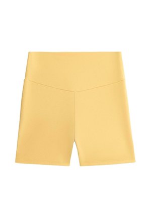 Pantaloncini da ciclismo gialli a vita alta con un dettaglio a cucitura a forma di V sulla parte anteriore e un design in tessuto liscio e aderente.