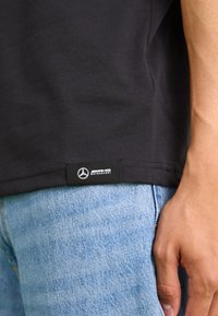 Puma AMG GRAPHIC TEE - Apdrukāts T-krekls - black