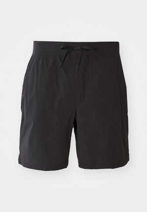 Svarte svømmebukser med elastisk midje og snor. Laget av lett materiale med en glatt, matt tekstur og uten synlige mønstre.