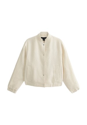 Cream-colored bomber jacket with a textured fabric, snap button closure, ribbed cuffs, and two front pockets.