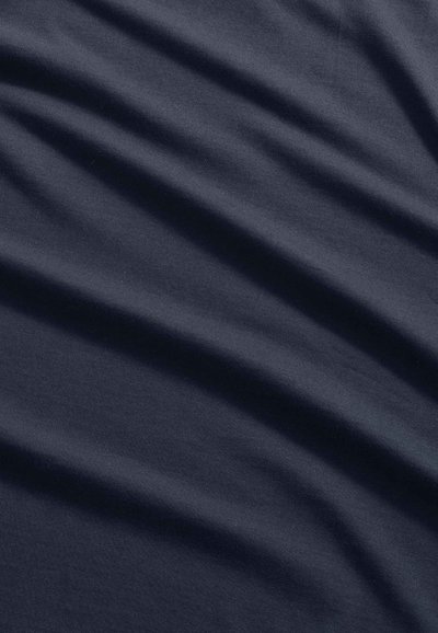 Dark gray fabric with subtle diagonal folds and a smooth texture, evenly lit to highlight the gentle creases.