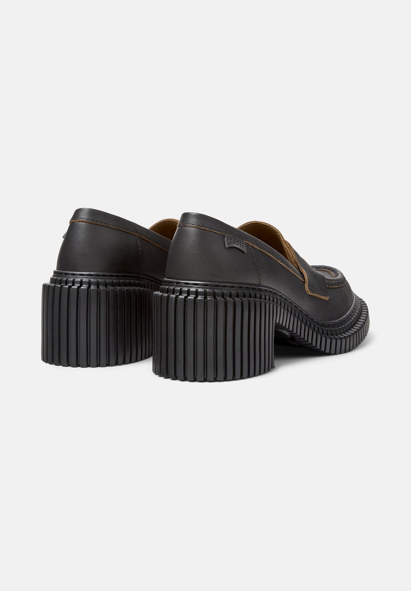 Schwarze Leder-Schuhe mit Blockabsatz, rutschfester Gummisohle und detaillierter Naht. Mit runder Schuhspitze und ohne Verschluss.