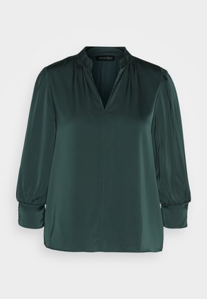 Donkergroen blouse van gladde stof, met een V-hals, geplooide schouders en lange mouwen met elastische manchetten. Rechte zoomontwerp.