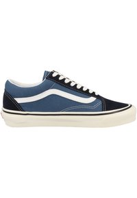 Blue canvas sneakers with navy accents, white logo stripe, black outsole, and white laces. Features cushioned collar and stitching details.