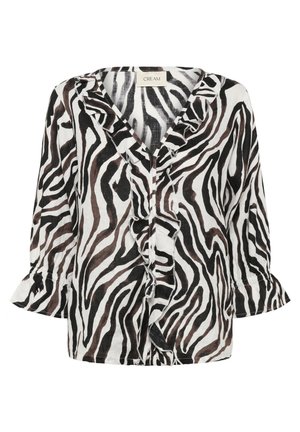 Blouse imprimée zébrée noir et blanc avec col en V à volants et manches évasées 3/4, tissu léger, et étiquette de marque "CREAM" à l'intérieur du col.