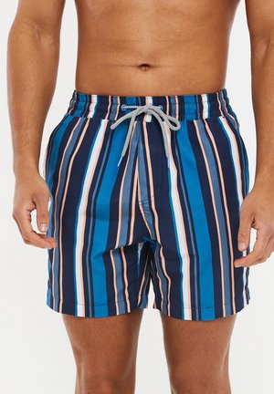 Badeshorts med lodrette striber i marineblå, lys blå og ferskenfarvet. Fremstillet af letvægtsmateriale med elastisk talje og snørre.