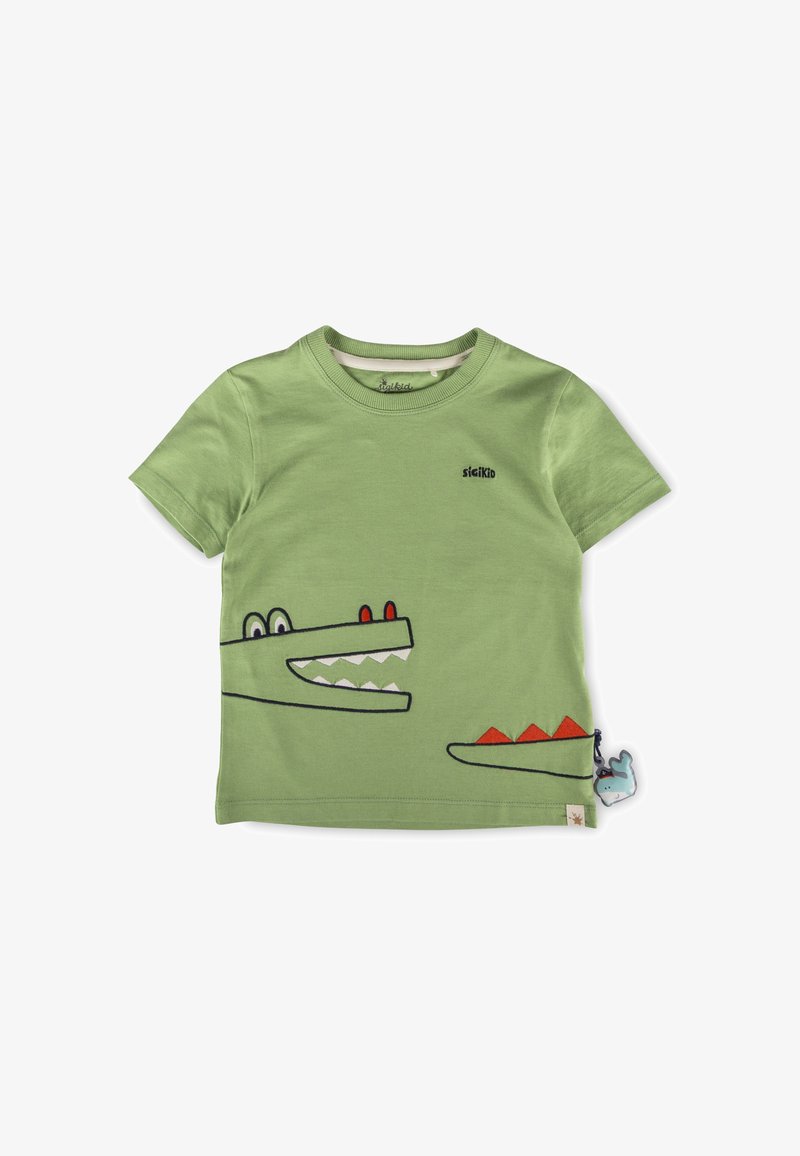 Hellgrünes Kinder-T-Shirt mit kurzen Ärmeln, Cartoon-Krokodil-Grafik, roten Details und einem kleinen befestigten blauen Plüschtier am Saum.